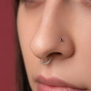 Nose & Septum Piercings hub hero, a delicate nostril stud and a fine septum ring in soft studio light