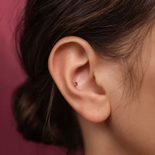 Healing Time, a calm healing ear piercing with a simple flat-back stud on settled skin