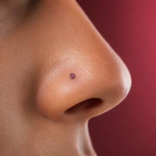 Nostril, a nostril piercing with a small gemstone stud on the side of the nose