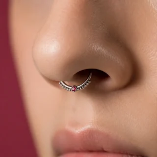 Septum, a septum piercing with a fine ring centered under the nose